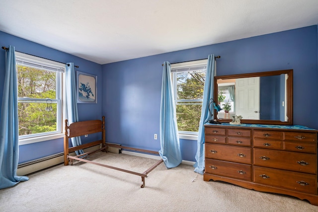 bedroom featuring light colored carpet, multiple windows, and baseboards