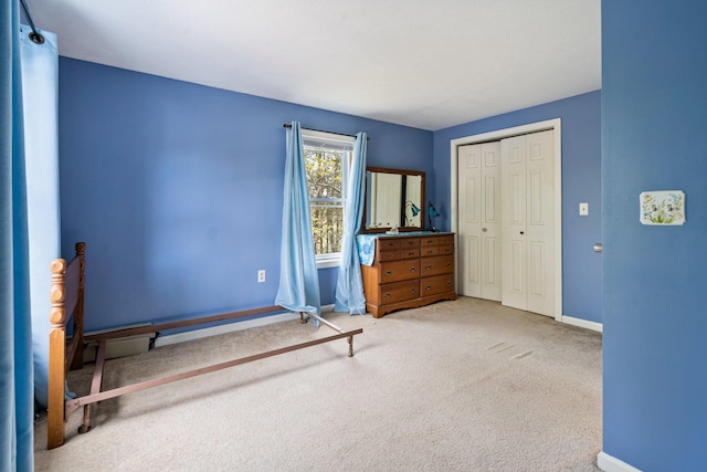 unfurnished bedroom featuring baseboards, a closet, and carpet floors