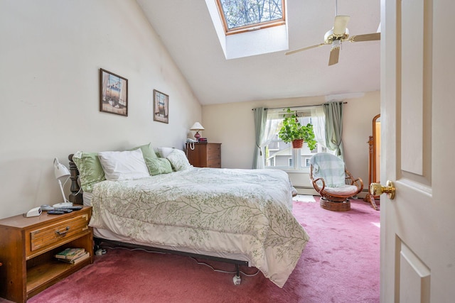 bedroom featuring carpet, vaulted ceiling, a skylight, and a ceiling fan