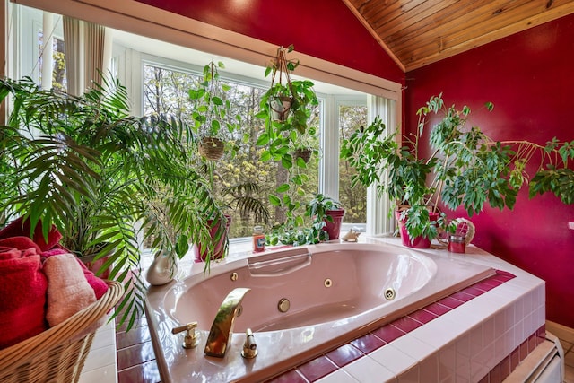 full bath featuring lofted ceiling, plenty of natural light, wood ceiling, and a tub with jets