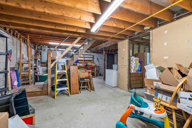 unfinished basement with washer / dryer, stairway, and electric panel