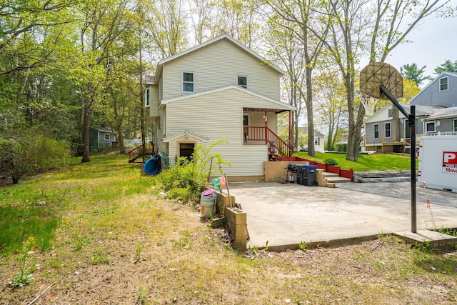 back of property featuring a patio and stairs