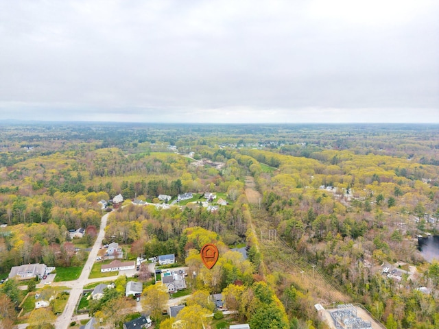 aerial view of property and surrounding area featuring a heavily wooded area