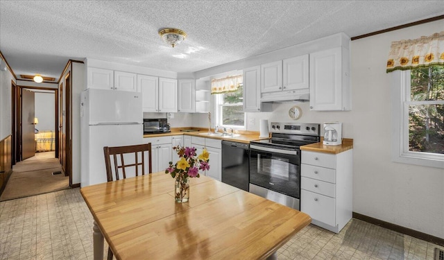1270 Main St, Mount Desert, ME 04660 - kitchen with black appliances, white cabinets, under cabinet range hood, light floors, and a sink