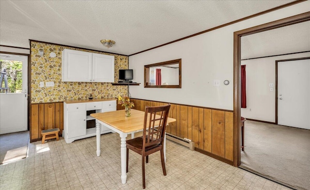 1270 Main St, Mount Desert, ME 04660 - dining area featuring a wainscoted wall, a textured ceiling, ornamental molding, wood walls, and a baseboard radiator