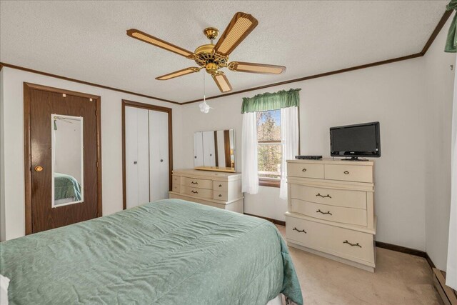 1270 Main St, Mount Desert, ME 04660 - bedroom with baseboards, crown molding, light colored carpet, a textured ceiling, and ceiling fan