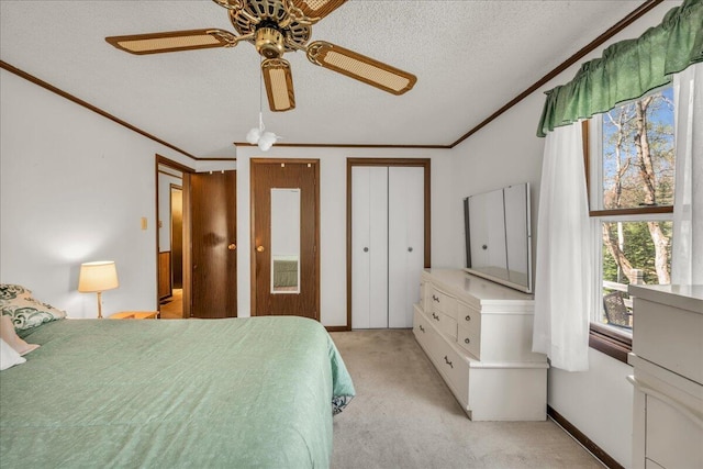 1270 Main St, Mount Desert, ME 04660 - bedroom featuring crown molding, light colored carpet, a textured ceiling, a ceiling fan, and multiple closets