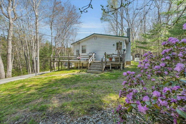 1270 Main St, Mount Desert, ME 04660 - rear view of property with a chimney, a deck, and a lawn