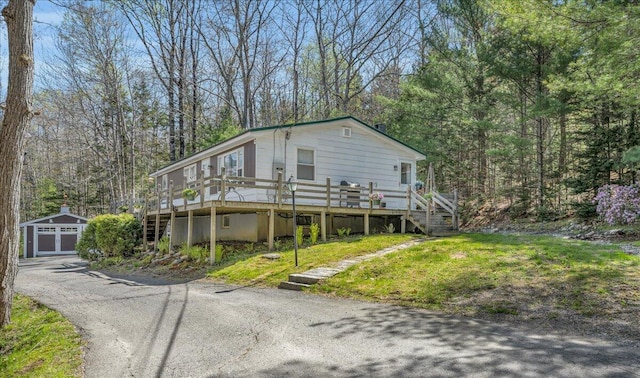 1270 Main St, Mount Desert, ME 04660 - view of front facade featuring stairs, an outdoor structure, and a deck