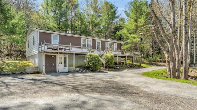 1270 Main St, Mount Desert, ME 04660 - view of front of house with a wooden deck and asphalt driveway
