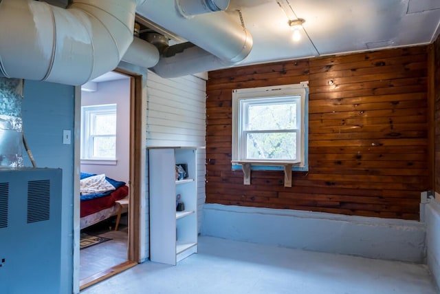 bathroom with wood walls and concrete floors