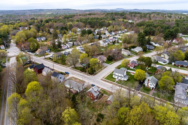 view of property location featuring nearby suburban area and a forest