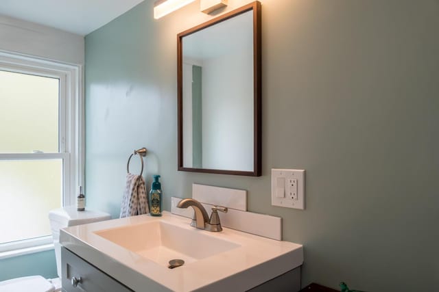 half bath with vanity and toilet