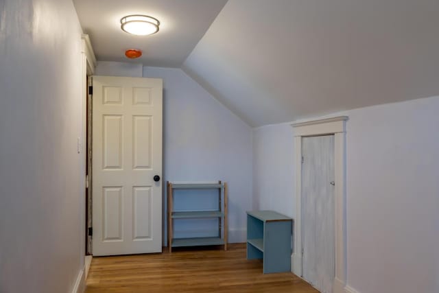 bonus room with wood finished floors, lofted ceiling, and baseboards