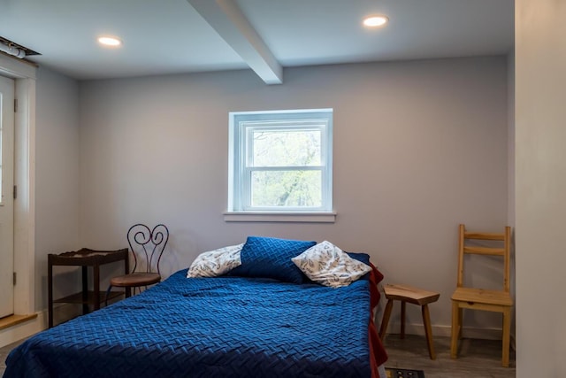 bedroom featuring beamed ceiling, recessed lighting, wood finished floors, and baseboards