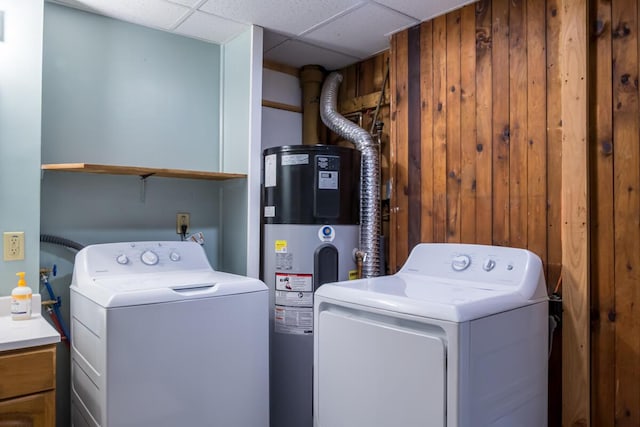 washroom with heat pump water heater, washing machine and clothes dryer, and cabinet space
