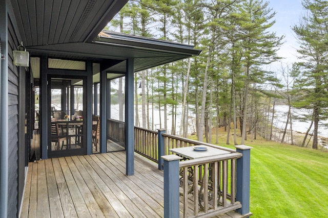 wooden terrace with a sunroom and a yard