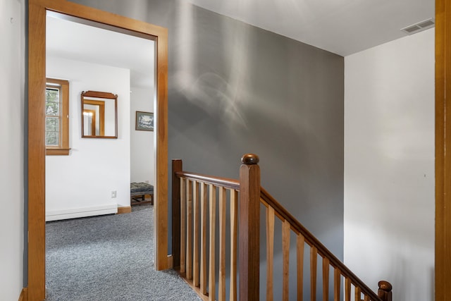 hallway featuring a baseboard radiator, an upstairs landing, carpet flooring, and baseboards