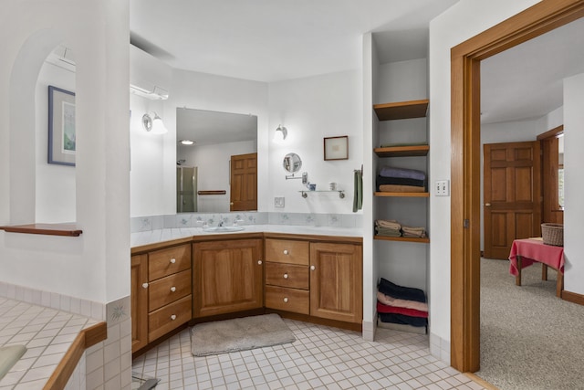 full bathroom featuring vanity, a shower with shower door, and tile patterned floors