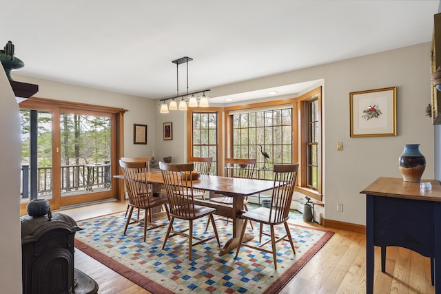 dining area featuring light wood-style floors and baseboards