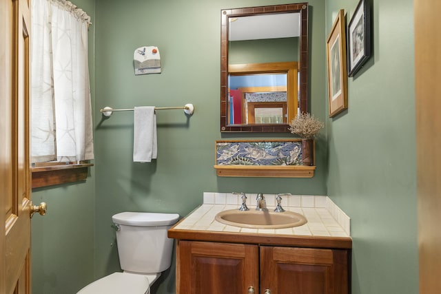 bathroom featuring toilet and vanity