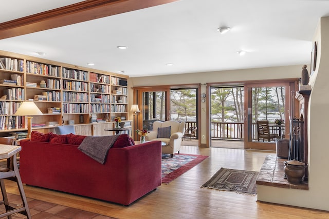 living room featuring healthy amount of natural light, wood finished floors, and recessed lighting
