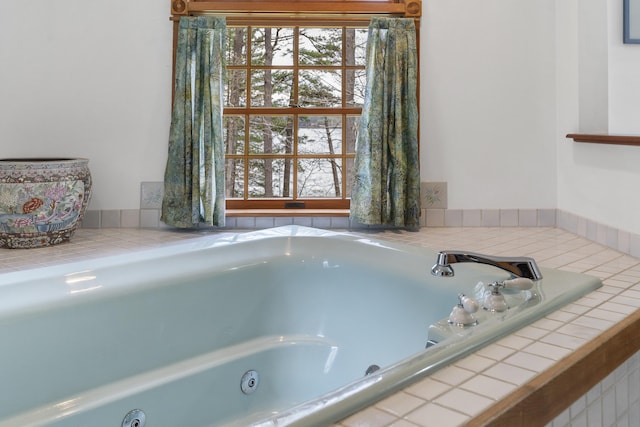 bathroom featuring a tub with jets