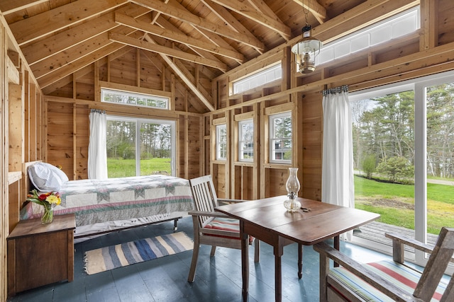 sunroom featuring vaulted ceiling and plenty of natural light