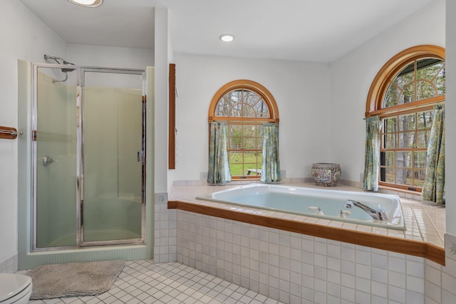 bathroom featuring a shower stall, tile patterned flooring, and healthy amount of natural light