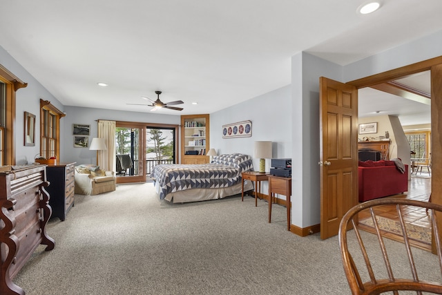 bedroom with carpet floors, access to exterior, a fireplace, recessed lighting, and ceiling fan