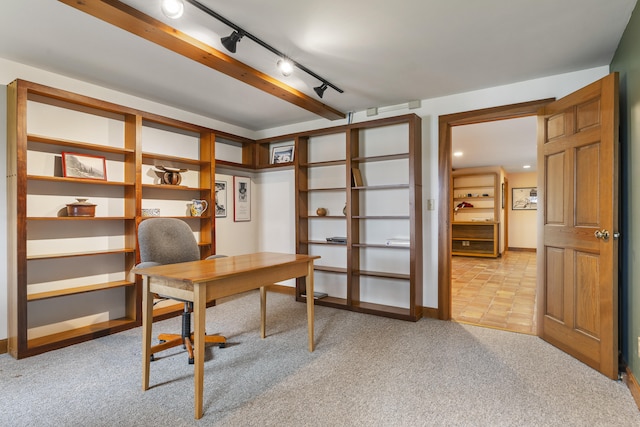 office space featuring light colored carpet, track lighting, and baseboards