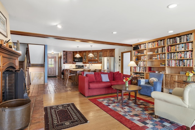 living area featuring light wood-style floors, a fireplace, and recessed lighting