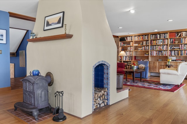 sitting room with hardwood / wood-style floors, a baseboard heating unit, recessed lighting, and baseboards