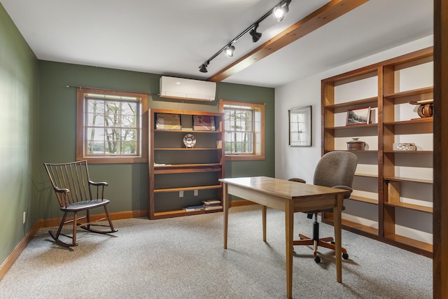 office area featuring a wall mounted air conditioner, carpet floors, baseboards, and track lighting