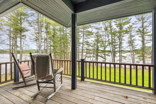 sunroom / solarium featuring a water view and lofted ceiling
