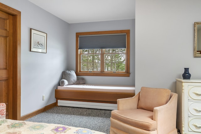 living area with baseboard heating, carpet flooring, and baseboards