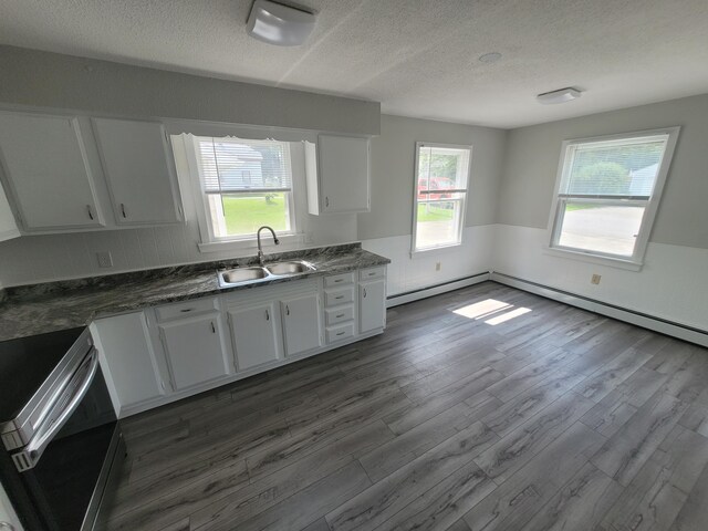 110 Lincoln St, Old Town, ME 04468 - kitchen featuring a sink, electric range, baseboard heating, a textured ceiling, and dark wood finished floors