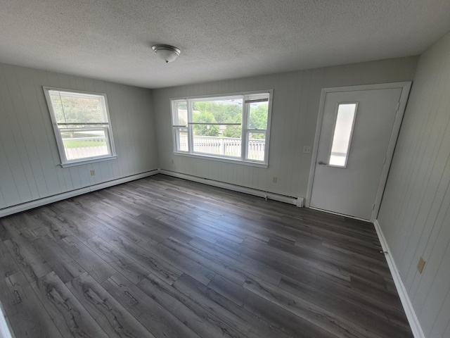 110 Lincoln St, Old Town, ME 04468 - unfurnished room featuring dark wood finished floors, a textured ceiling, plenty of natural light, and a baseboard radiator