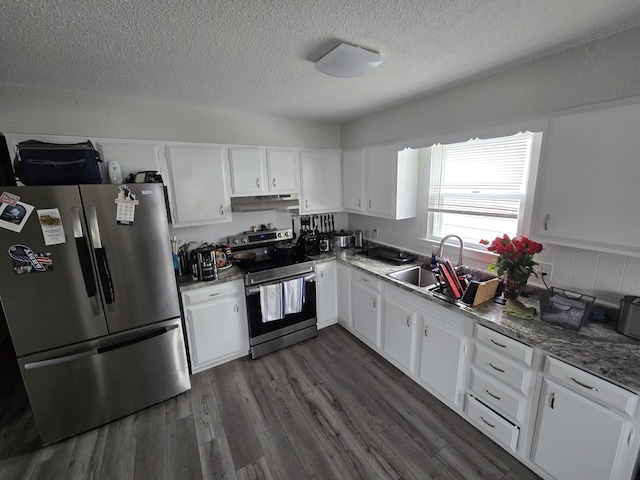 110 Lincoln St, Old Town, ME 04468 - kitchen with stainless steel appliances, under cabinet range hood, white cabinetry, a textured ceiling, and dark wood-style flooring