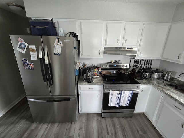 110 Lincoln St, Old Town, ME 04468 - kitchen featuring stainless steel appliances, under cabinet range hood, dark wood finished floors, and white cabinets