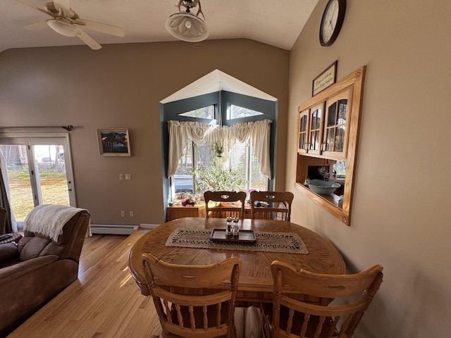 43 Webb River Dr, Dixfield, ME 04224 - dining space with lofted ceiling, baseboard heating, light wood-type flooring, and a ceiling fan