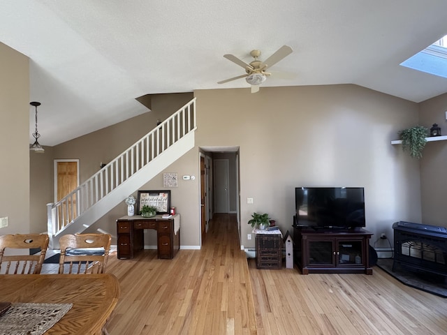 43 Webb River Dr, Dixfield, ME 04224 - living area with stairs, lofted ceiling, ceiling fan, light wood-style flooring, and a baseboard radiator
