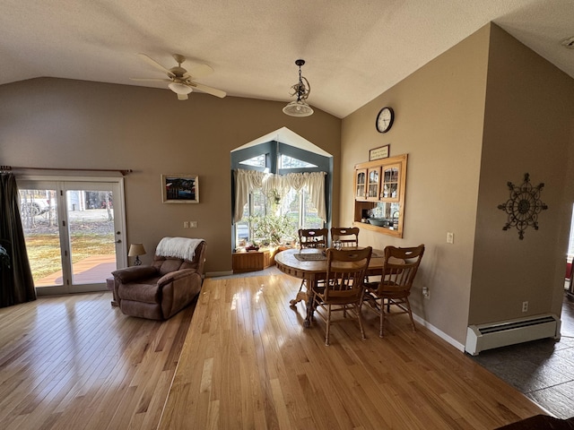 43 Webb River Dr, Dixfield, ME 04224 - dining space featuring lofted ceiling, a baseboard radiator, wood finished floors, ceiling fan, and baseboards