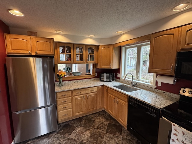 43 Webb River Dr, Dixfield, ME 04224 - kitchen with black appliances, a sink, a textured ceiling, glass insert cabinets, and light stone countertops