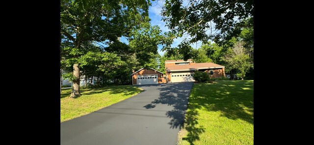 43 Webb River Dr, Dixfield, ME 04224 - view of front of house featuring a front lawn, asphalt driveway, and a detached garage