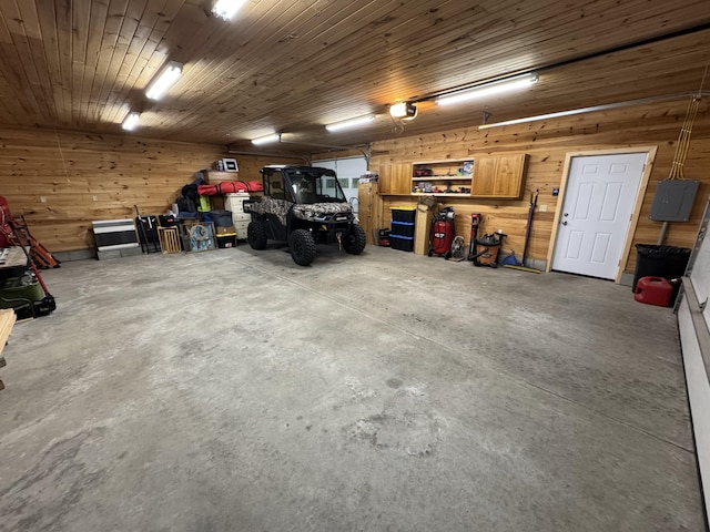43 Webb River Dr, Dixfield, ME 04224 - garage with a garage door opener, electric panel, and wood walls