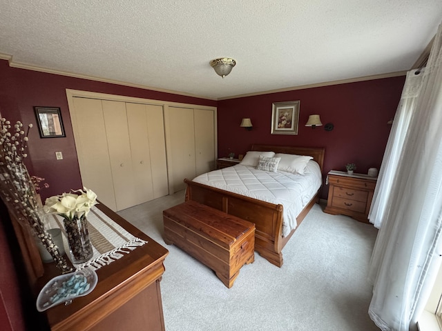 43 Webb River Dr, Dixfield, ME 04224 - bedroom with multiple closets, carpet floors, a textured ceiling, and ornamental molding