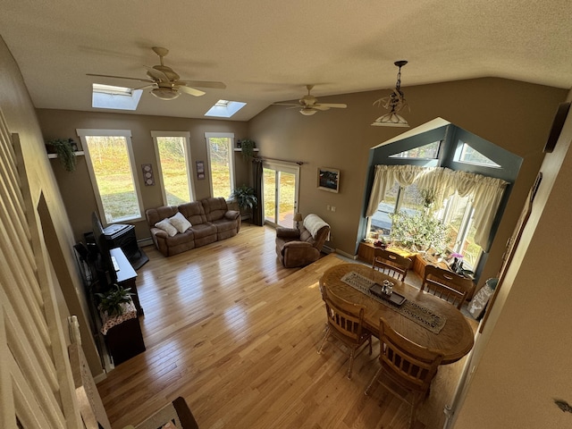 43 Webb River Dr, Dixfield, ME 04224 - living room with a skylight, lofted ceiling, a ceiling fan, light wood-type flooring, and a textured ceiling