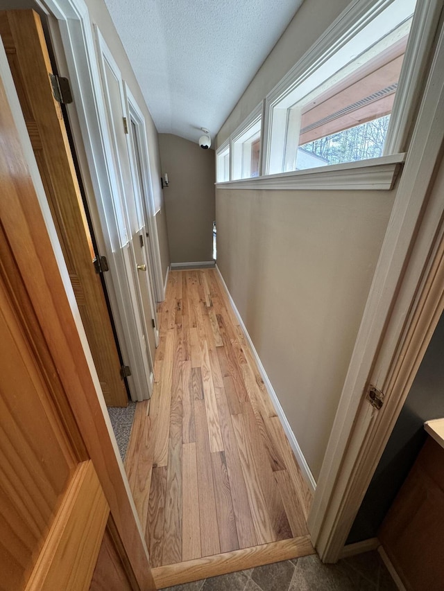 43 Webb River Dr, Dixfield, ME 04224 - hallway featuring a textured ceiling, baseboards, and light wood-style flooring