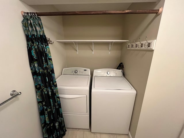 clothes washing area with separate washer and dryer and light tile patterned floors